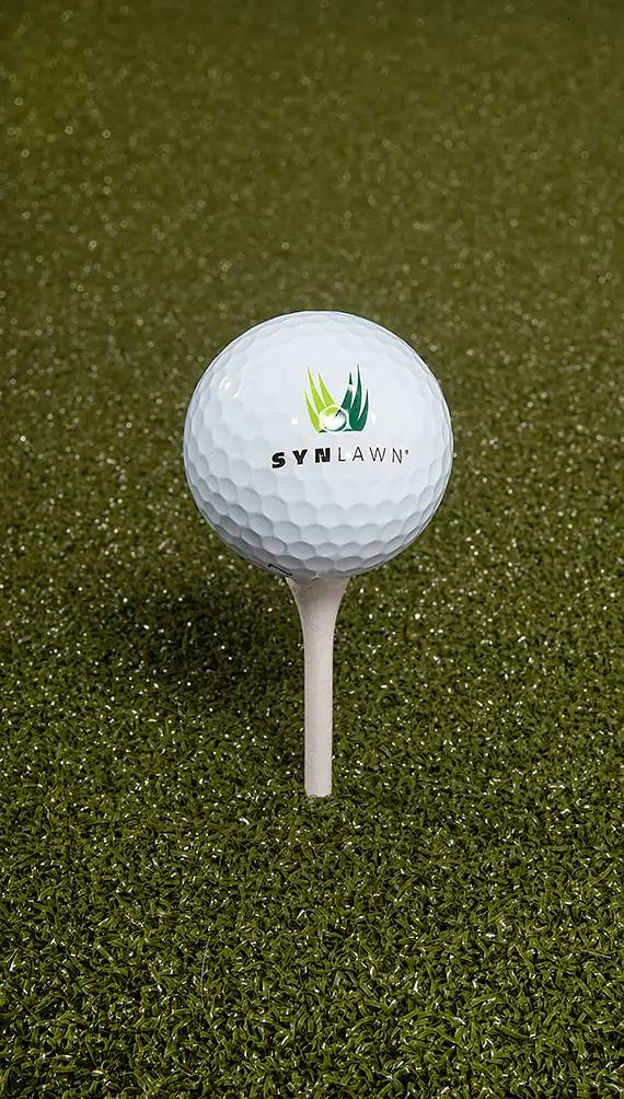 golf-ball-faq-image SYNLawn branded golf ball on artificial grass tee